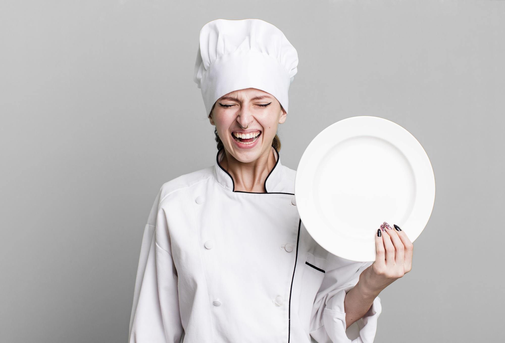 Chef smiling holding plate near window